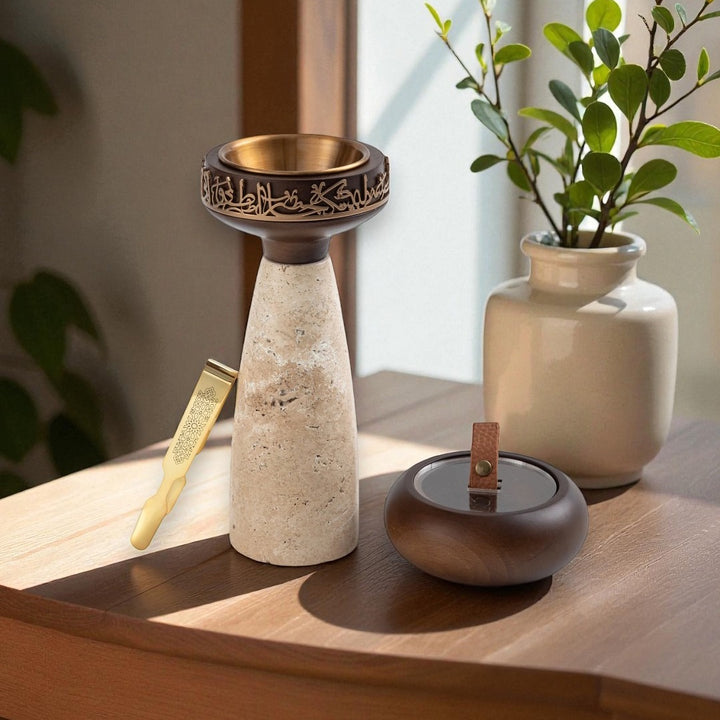 Decorative items including a tall ceramic vase with a bronze top, a smaller round vase, and a potted plant on a wooden surface.