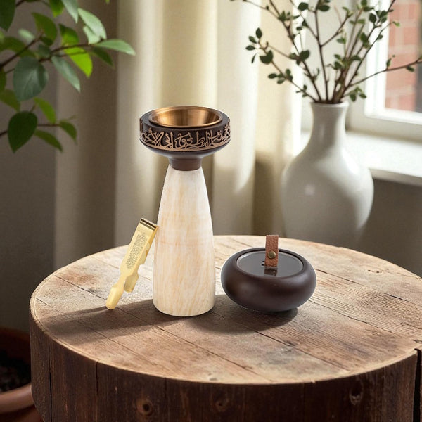 Decorative items on a wooden surface with plants in the background