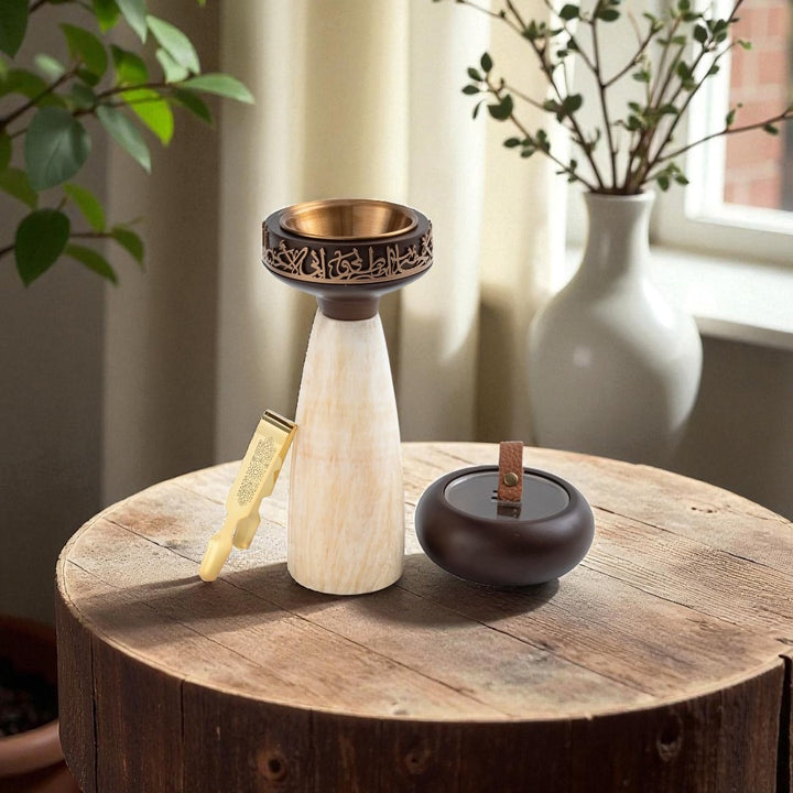 Decorative items on a wooden surface with plants in the background