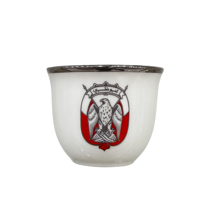White ceramic cup with a red and black emblem featuring an eagle on a white background
