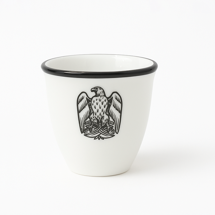 White cup with black rim and eagle emblem on a white background