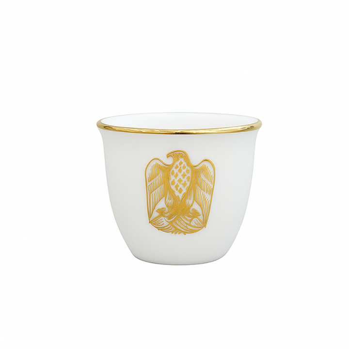 White cup with gold rim and emblem on a white background